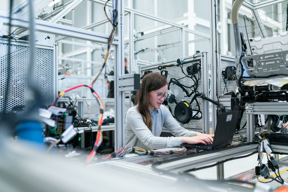 Engineer working on network equipment with a laptop